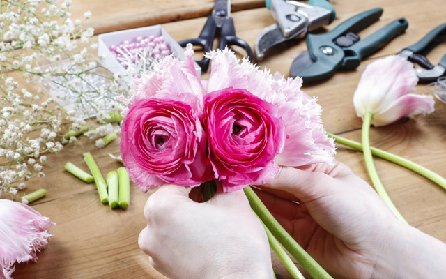 A close-up of hands flower arranging